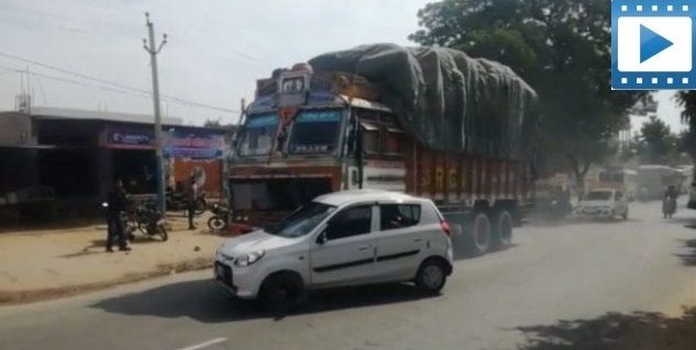 truck driver PUSHING a car attached to the bonnet for 2km